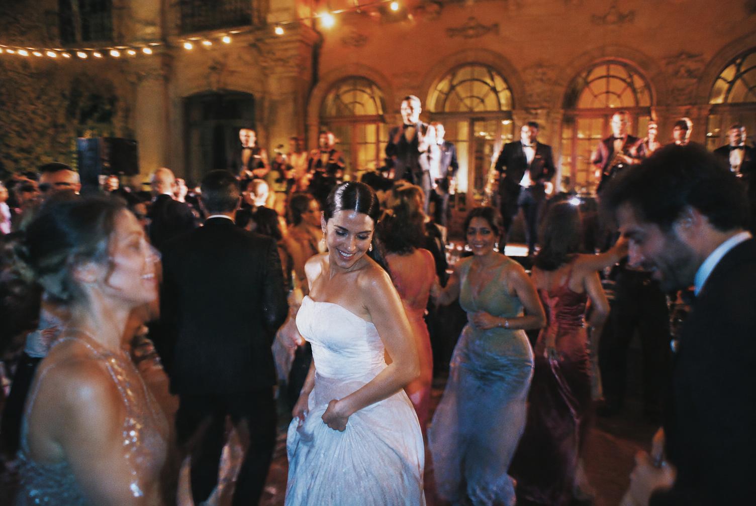 Guests and live band on a warmly lit dance floor at an Italian palazzo reception